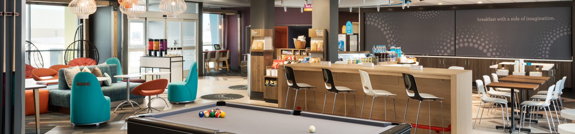 Photo of lounge with pool table, breakfast bar, and large windows that was built by Aspire.